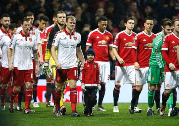 Jay McEveley leads out Sheffield United at Old Trafford earlier this season