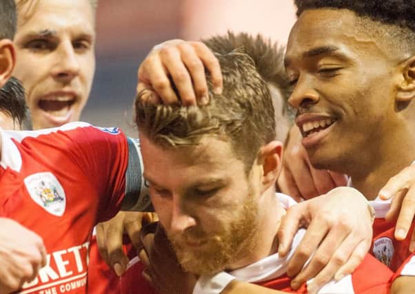 Barnsley's Sam Winnall celebrates with teammates after heading home the first goal at Oakwell. 

Picture Dean Atkins