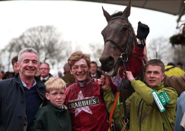 Owner Michael O'Leary (left) and jockey David Mullins celebrate with Rule The World after winning the Crabbie's Grand Nationall. Photo: David Davies/PA Wire
