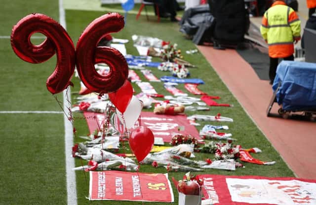 Flowers and balloons at the side of the pitch during the last memorial service to be held at Anfield