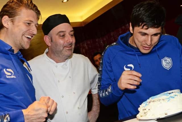 Sheffield Wednesday footballers Glenn Loovens and Fernando Forsetieri decorate their cake, while Sous Chef Lee Crookes watches on