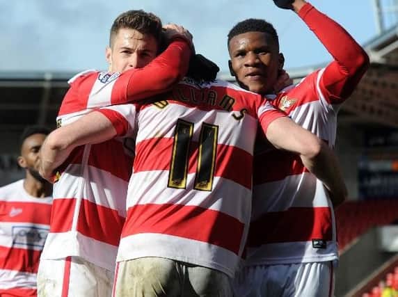 Doncaster's Andy Williams celebrates his penalty with Tommy Rowe and Riccardo Calder. AHPIX.COM