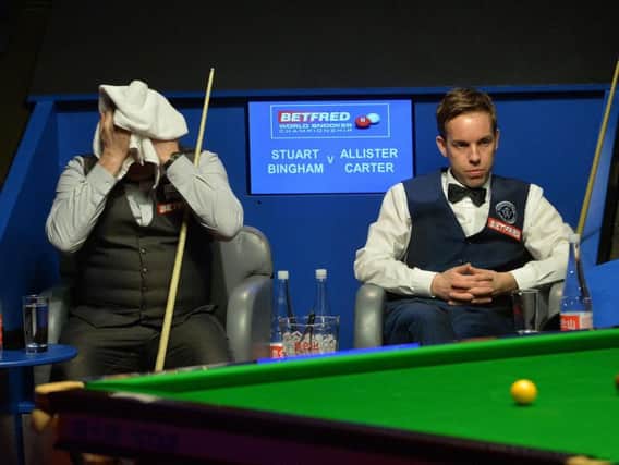 Stuart Bingham (left) and Ali Carter during their first round match during day one of the Betfred Snooker World Championships at the Crucible Theatre, Sheffield. PRESS ASSOCIATION Photo.