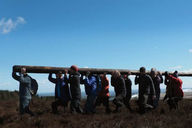 The new Stanage Pole: the pole is carried out from the moor by volunteers
