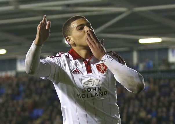 Che Adams  celebrates scoring the second goal during the Sky Bet League One match at The Greenhouse Meadow