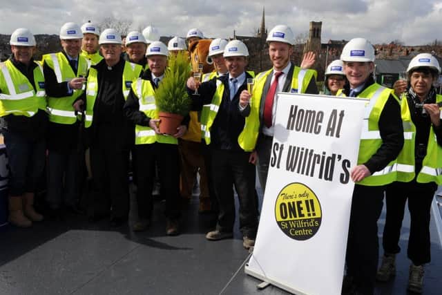 Glasses are raised at a topping out ceremony for the new residential centre created by St Wilfrid's. Picture: Andrew Roe