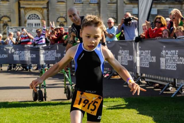 Bailey Matthews from Doncaster crosses the finish line to complete his first ever triathlon at Castle Howard last year.