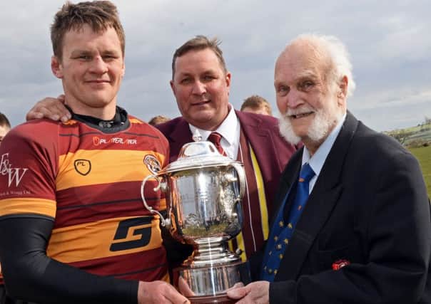 Terry Owen-Smith, National 3 North League Secretary, presents the trophy to Sheffield Tigers Biff Pearson and Ian Wragg, President. Picture: Marie Caley