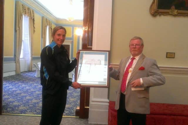 The Civic Mayor Paul Wray presents Doncaster Belles captain Leandra Little with a civic gift of a historic picture of the Mansion House at a reception in the team's honour.