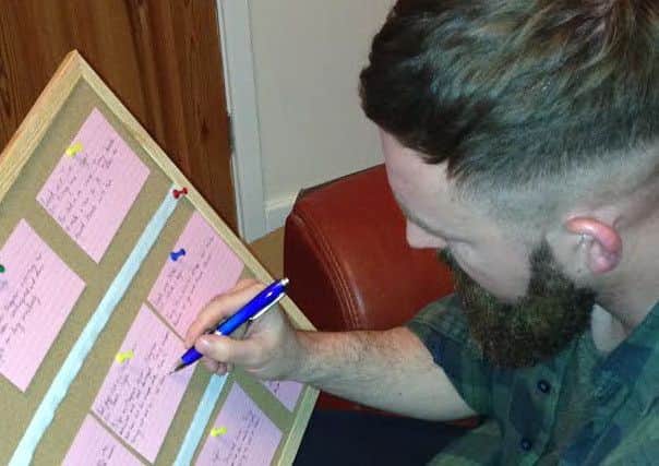 Shaun Needham working on his script.