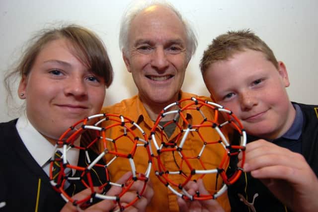 Sir Harry Kroto with Holly Booker and Connor Schofield with the Buckyball he is famous for at Sheffield University