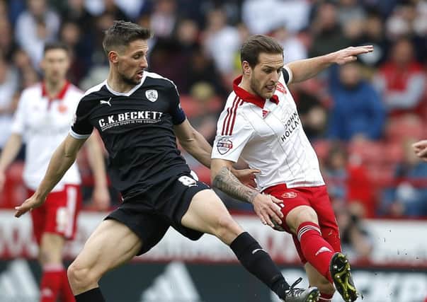 Conor Hourihane of Barnsley tussles with Billy Sharp of Sheffield Utd