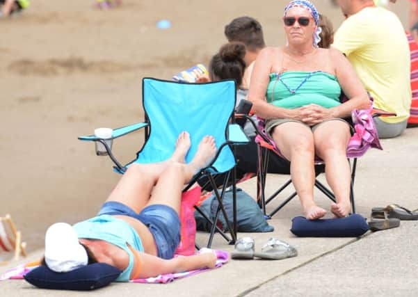 Pictured - Sunbathers enjoying the hot and sunny weather in Blackpool, Lancs., on a hot and sunny day on the Lancashire coastal city. The Met Office has issued a Level 2 health alert for much of England from tomorrow as forecasters predict temperatures will soar to 30C before rising to a sweltering 35C on Wednesday. 

Thomas Temple/rossparry.co.uk