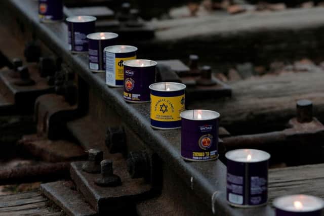 Students and teachers placed candles on the tracks in Auschwitz Birkenhau