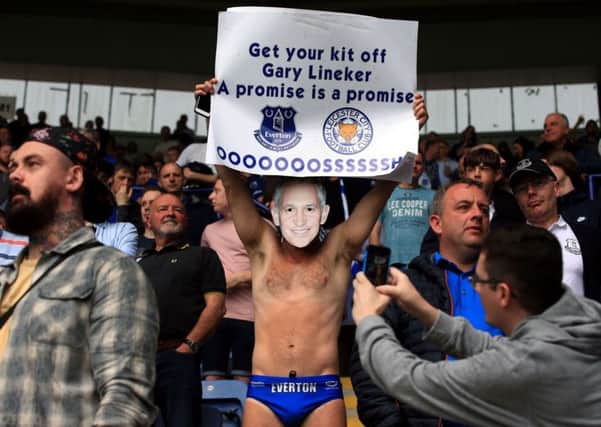 Everton fan Michael Cullen aka Speedo Mick holds a sign saying 'Get your kit off Gary Lineker, a promise is a promise'