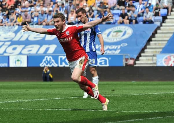 Barnsley's Sam Winnall scores the second goal as they reach the play-offs with victory at Wigan. Photo: Keith Turner