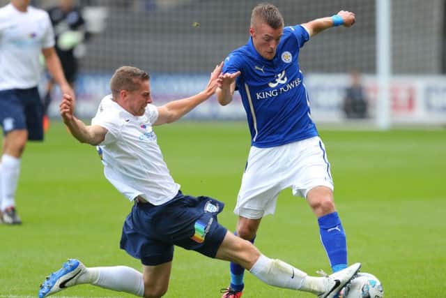 Preston North End's Calum Woods challenges Leicester City's Jamie Vardy