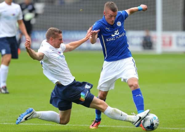 Preston North End's Calum Woods challenges Leicester City's Jamie Vardy