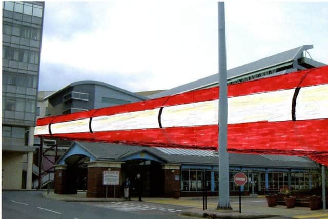 The space age elevated moving walkway is designed to transport passengers around the city. (Photo: Richard Hargate).