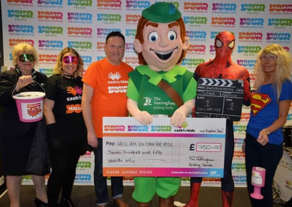 The Nottingham Building Society team hands over a Â£750 cheque to the Hallam FM Superhero Day campaign
