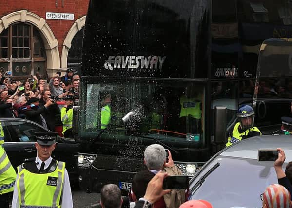 A can is thrown at the Manchester United team coach