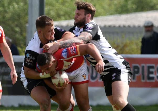 Sheffield Eagles' Elliot Minchella is thwarted by the Workington defence. Picture: Andrew Roe