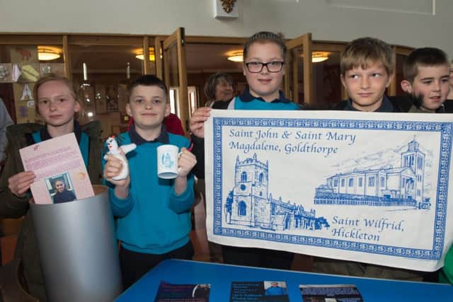 Time capsule buried at Goldthorpe Church by local school children from Goldthorpe Primary
Maison, Brandon, Courtenay and Reo with some of the items that will go in the capsule