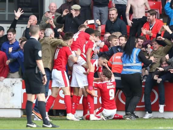 Barnsley players and fans celebrate the Reds third goal, scored by Sam Winnall