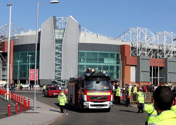 A fire engine outside the ground after the Barclays Premier League match at Old Trafford, Manchester is abandoned.  Photo: Martin Rickett/PA Wire.