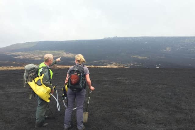 After the fire, two National Trust rangers attended the moorland to damp down hotspots in the peat. Picture submitted.