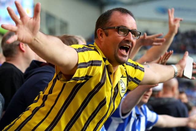 A Sheffield Wednesday fan celebrates his side's first goal of the game in the stands during the Sky Bet Championship play off, second leg match at the AMEX Stadium, Brighton.
