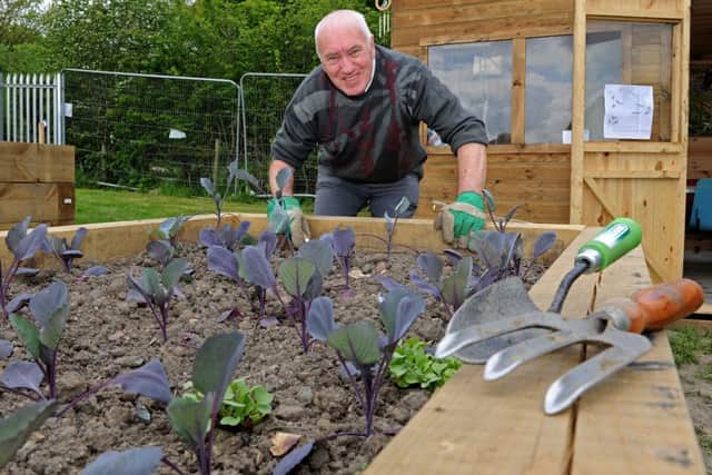 Stuart Cole works on the raised bed at the St Saviour's Church community allotment. Picture: Andrew Roe