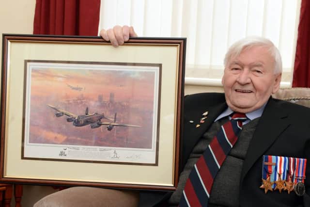 Wartime airman Ken Johnson, aged 90, of Balby, with a picture of a Lancaster.