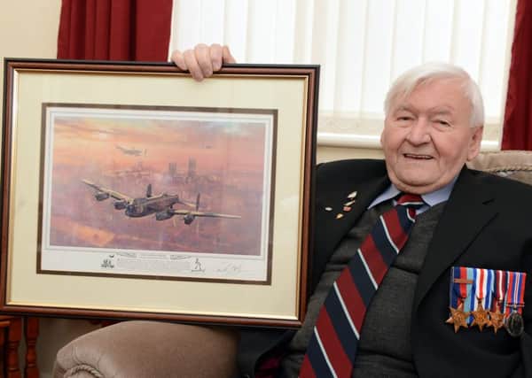 Wartime airman Ken Johnson, aged 90, of Balby, with a picture of a Lancaster.