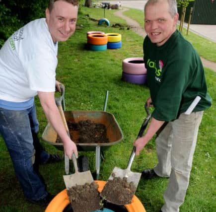 Richard Spooner and Chris Hall, of Waitrose, make a wormary at a Give and Gain Charity Day at Mansel Primary School. Picture: Andrew Roe