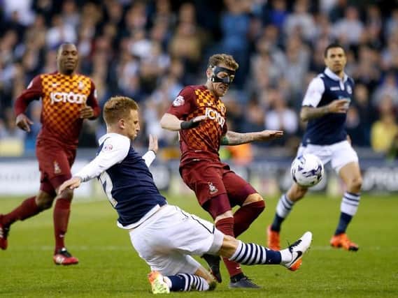 Millwall's Byron Webster (second left) and Bradford City's Billy Clarke (centre) battle for the ball during the Sky Bet League One Play-Off Semi Final, Second Leg match at The Den, London. PRESS ASSOCIATION Photo