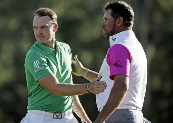 Danny Willett, of England, is congratulated by Lee Westwood, of England, on the 18th green after finishing the final round of the Masters golf tournament Sunday, April 10, 2016, in Augusta, Ga. (AP Photo/Chris Carlson)