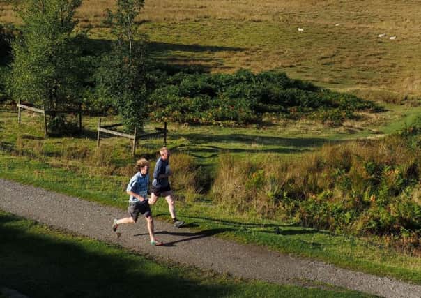 Runners on the bridleway near Duke's Seat at Longshaw