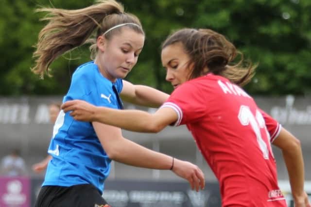 Hannah Cain (blue) in first half action against Bristol. Cain was stretchered off in the second half after a bad injury. Photo: Julian Barker