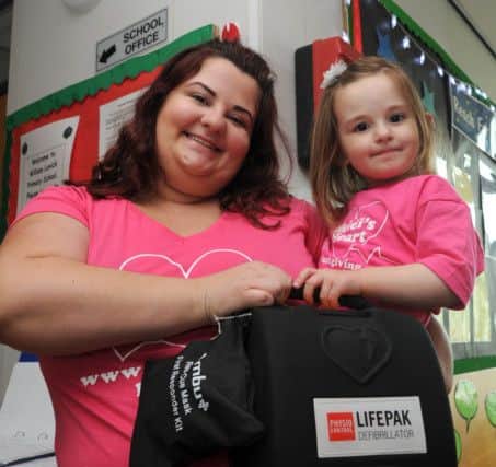 Sammy Mellor and Heidi Mellor at William Levick Primary School, where a defibillator has been installed as part of trying to raise awareness through a charity Hand on Heart, as Heidi was born with long qt syndrome. Picture: Andrew Roe