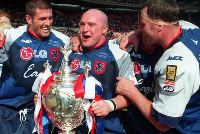 Micheal Jackson, Johnny Lawless and Paul Broadbent get their hands on the trophy (Photo: Paul Chappells)