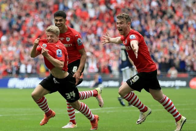 Barnsley's Lloyd Isgrove (left) celebrates scoring his side's third goal of the match with team-mates during the Sky Bet League One Play-Off Final at Wembley Stadium, London. PRESS ASSOCIATION Photo