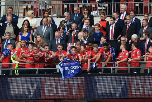 Barnsley players celebrate with the trophy after winning the Sky Bet League One Play-Off Final at Wembley Stadium, London. PRESS ASSOCIATION Photo