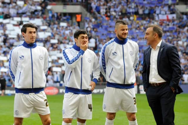 Kieran Lee, Fernando Forestieri and Daniel Pudil talk with Carlos Carvalhal before the game
