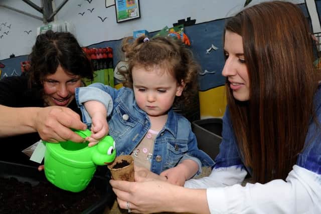 Imogen Farah waters her plant pot with Nik and Victoria Middleton, of Ferndale Garden Centre as part of National Children's Gardening Week, at Ferndale Garden Centre. Picture: Andrew Roe