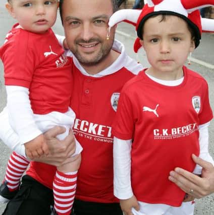 Barnsleys fan Matt Wood with Harley and Emerson await their heroes at Oakwell