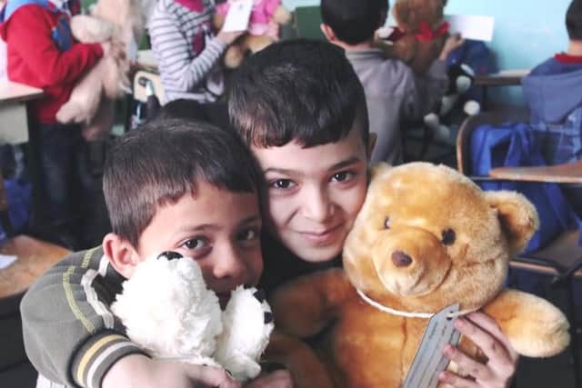 Refugees receiving teddy bears as part of a charity appeal from Sheffield youngsters.