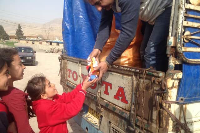 Refugees receiving toys.