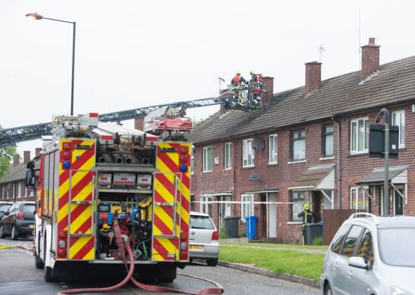 Firefighters damp down following a fire on Leighton Road in Gleadless