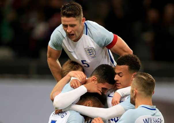 England's Chris Smalling (centre) celebrates scoring his side's first goal of the game with team-mates during an International Friendly at Wembley Stadium, London. PRESS ASSOCIATION Photo